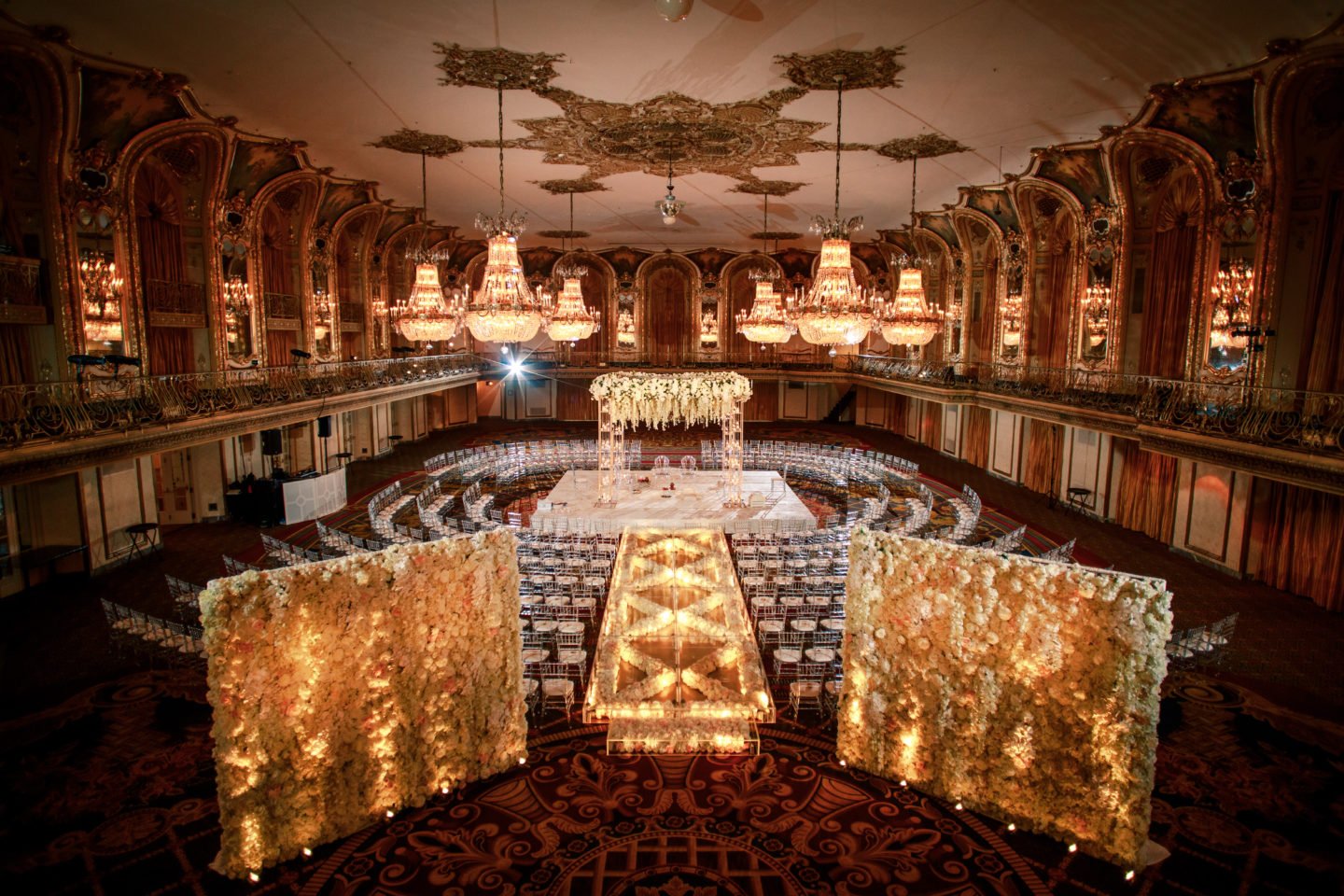 https://yannidesignstudio.com/app/uploads/2019/08/elevated-custom-lucite-runway-expensive-hindu-ceremony-indian-wedding-ceremony-hilton-chicago-glowing-lucite-runway-floral-wall-expensive-hindu-mandap-hilton-chicago-grand-ballroom-gorgeous-floral-runway-1440x960.jpg