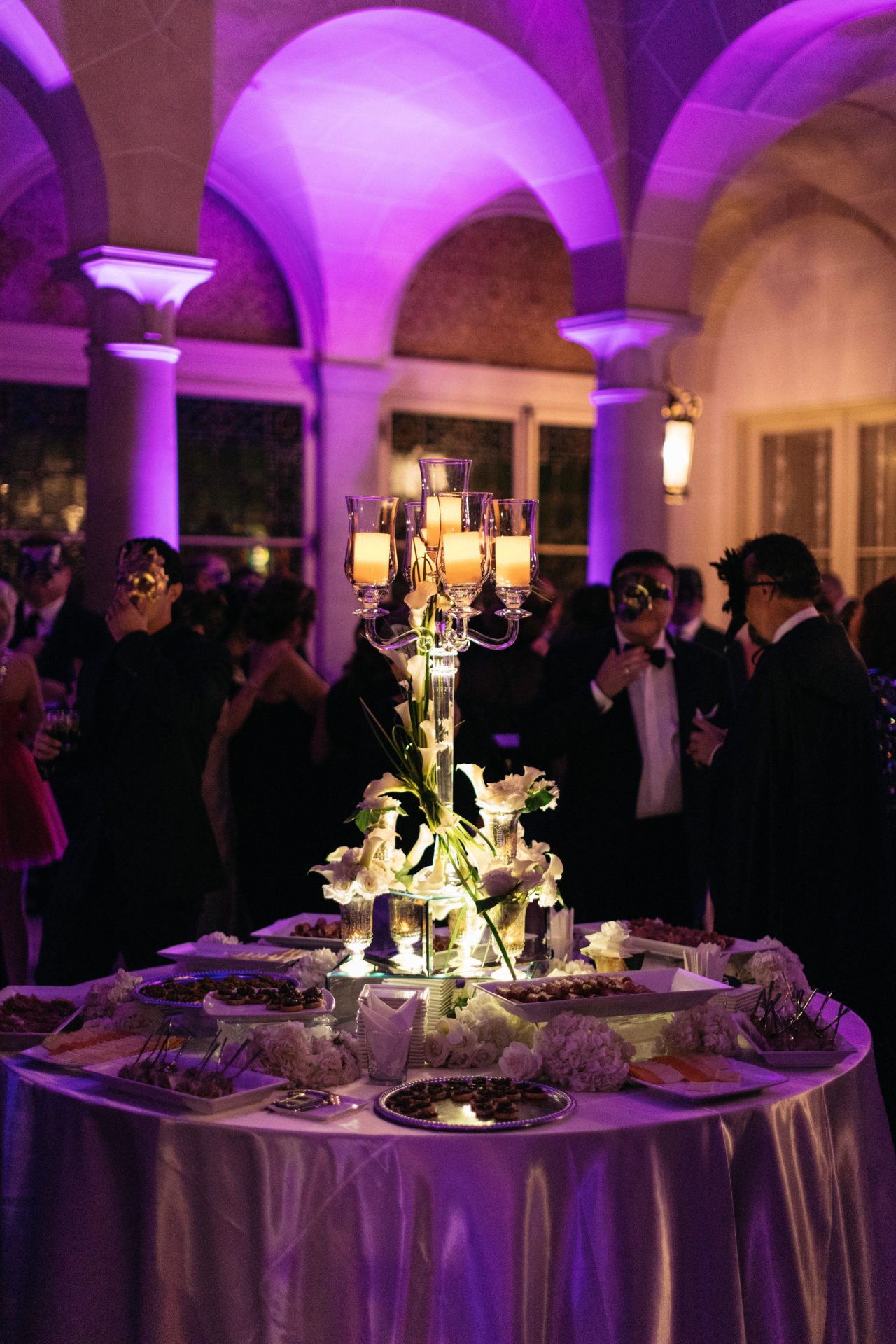https://yannidesignstudio.com/app/uploads/2019/08/tall-floral-centerpieces-candle-lights-decor-unique-arrangements-decoration-ideas-cuneo-mansion-and-gardens-masquerade-birthday-party.jpg